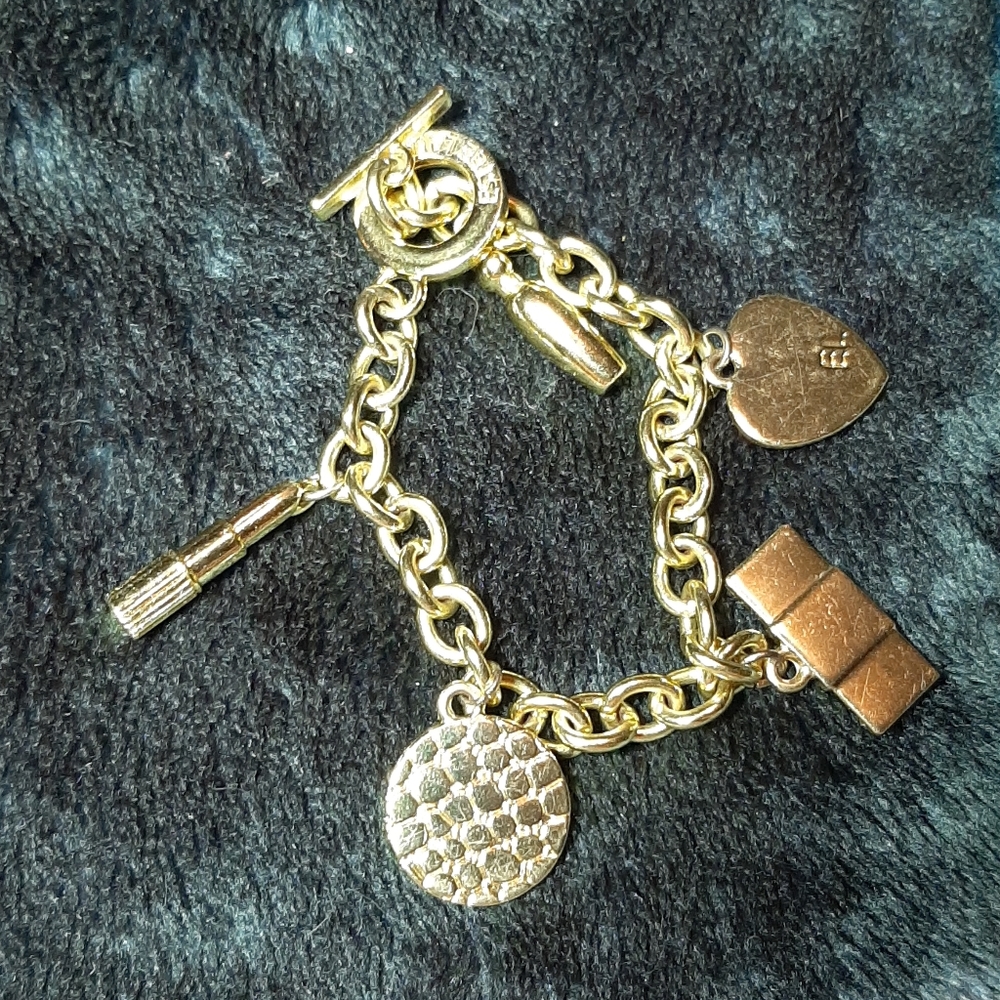 Estee Lauder gold tone charm bracelet
